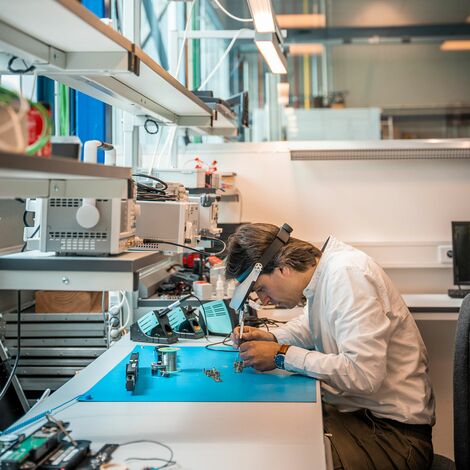 Expert working on small electronics in the Technology Centre.